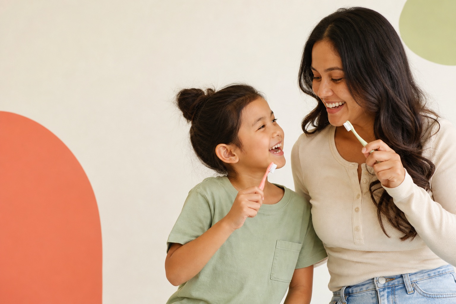 Parent and child holding toothbrushes and smiling
